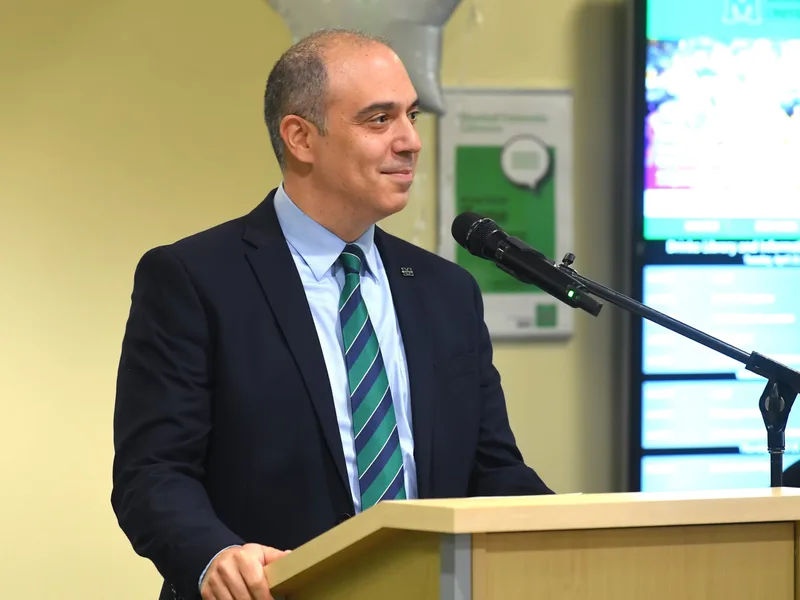 Ed speaking at a podium