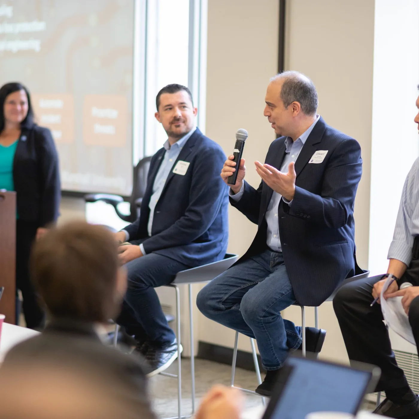 Panelists speaking on stage