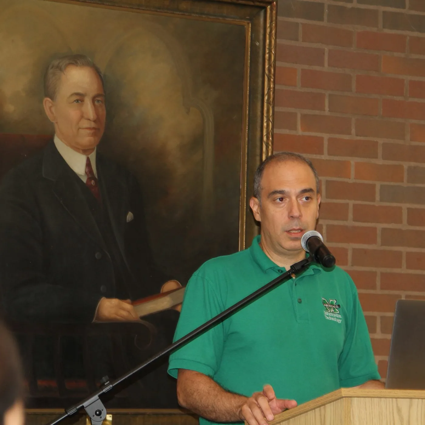 Ed presenting at a podium